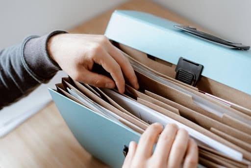 A calendar and company ownership documents laid out on a desk, marking a filing deadline.